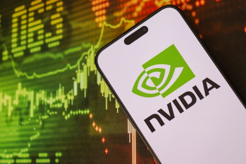 Nvidia logo on smartphone with financial chart behind it