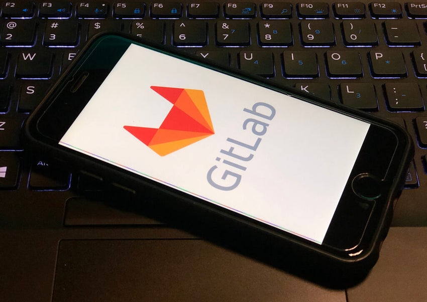 GitLab log on a smartphone screen on top of a computer keyboard