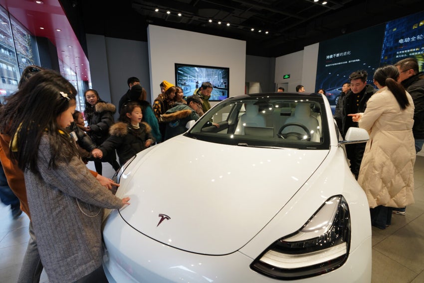 Crowd around a Tesla vehincle in Chengdu, Sichuan China