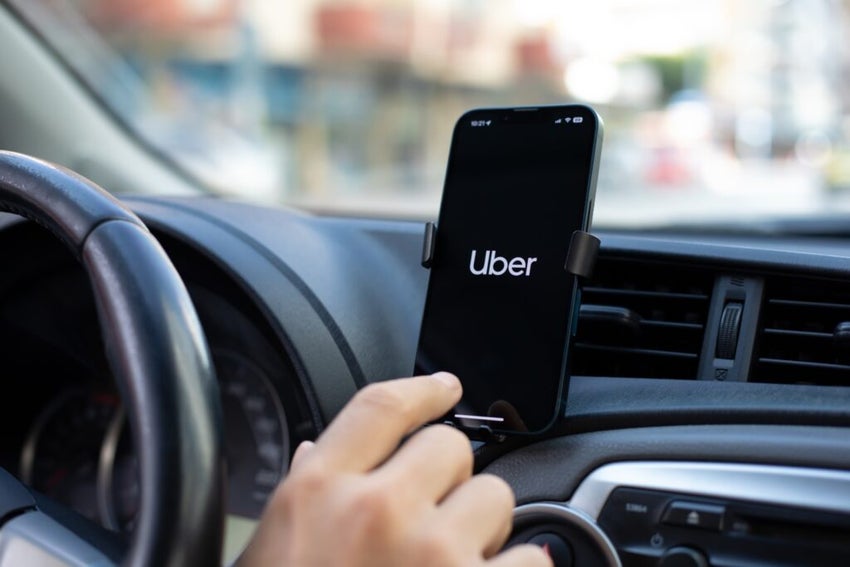 Uber logo on a phone mounted in a car