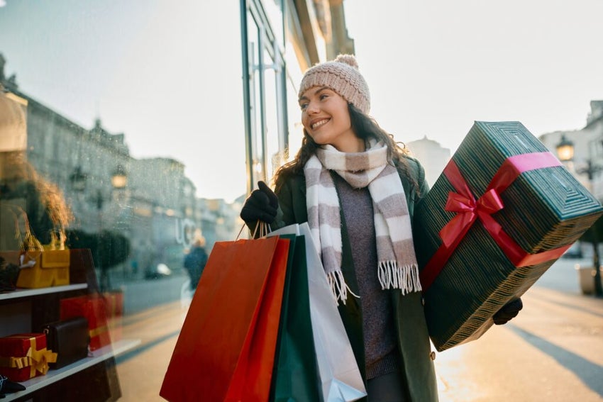 Woman holiday shopping and holding two shopping bags