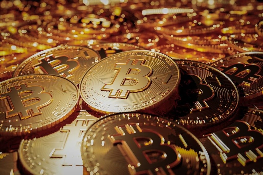 bitcoin, a heap of golden bitcoins with focus on one single bitcoin - 3D illustration