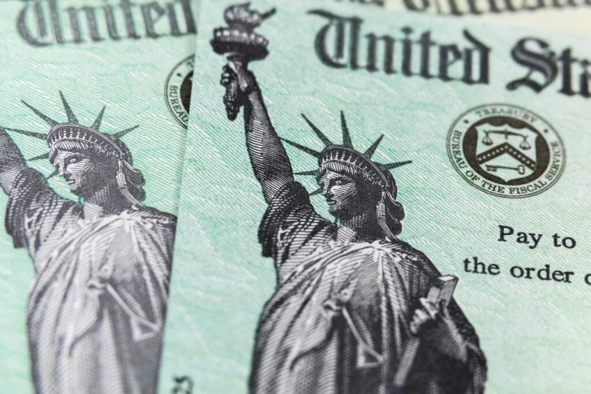 Macro view of the Statue of Liberty on two United States Treasury checks.
